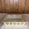 Harvest Charm | Vintage Pyrex Yellow Casserole with Black Amish Butterprint – Brass Cradle Included