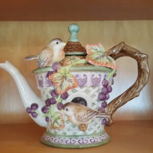 Fitz and Floyd Château Garden teapot featuring a ceramic birdhouse design with birds, grapevine, and a rustic handle, handcrafted in China.