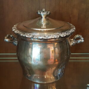 Polished silverplate ice bucket with floral garland trim and ornate scroll handles, made by International Silver Company in the Countess pattern. The matching domed lid features a raised floral finial.